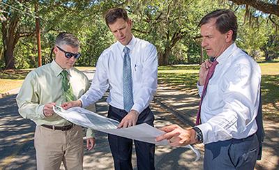 Kevin Graham, center, goes over expansion plans with FSU Associate General Counsel Dustin Dailey, left, and FSU Vice President for University Advancement Tom Jennings.
